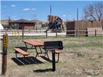 A picnic bench and fire pit at CHEYENNE RV RESORT BY RJOURNEY - thumbnail