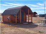 A cabin with a swing on the porch at CHEYENNE RV RESORT BY RJOURNEY - thumbnail