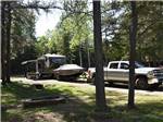 Truck, boat and camper in campsite at WAWA RV RESORT & CAMPGROUND - thumbnail