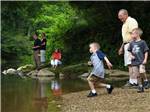 Kids and adults enjoying the river at STATE FAIR OF WEST VIRGINIA CAMPGROUND - thumbnail