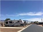 A paved road between the RV sites at DESERT SKIES RV RESORT - thumbnail