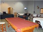 A red pool table sits among tables at BUSHMAN'S RV PARK - thumbnail