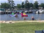 View larger image of People playing in the water at TAW CAW CAMPGROUND  MARINA image #2