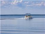 A boat cruises in the water at Taw Caw Campground & Marina - thumbnail