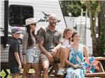 A family sitting at a picnic table at Bayberry RV Park - thumbnail