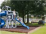 Children on the slide at the playground at Bayberry RV Park - thumbnail