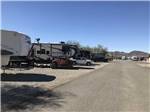 View larger image of Trailers camping at campsite with red and black ATV at QUAIL RUN RV PARK image #7