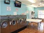Laundry room with washer and dryers at CINNAMON CREEK RV PARK - thumbnail