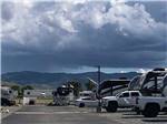 A row of trailers parked in gravel sites at Fairgrounds RV Park - thumbnail