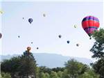 A group of hot air balloons in the air at CORONADO VILLAGE RV RESORT - thumbnail