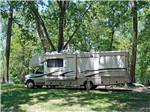 A class C motorhome in A RV site under trees at MILLPOINT RV PARK - thumbnail