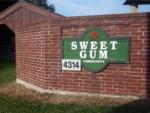 Park sign on red brick wall at entrance at SWEET GUM MOBILE HOME AND RV COMMUNITY - thumbnail