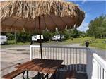 A patio table with an umbrella at THE WILLOWS RV PARK & CAMPGROUND - thumbnail