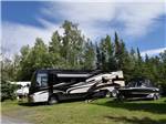 A motorhome in a grassy RV site at THE WILLOWS RV PARK & CAMPGROUND - thumbnail