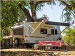Trailer camping at campsite at THOUSAND TRAILS PONDEROSA - thumbnail