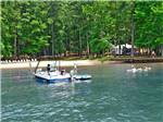 People boating and rafting on the lake at THOUSAND TRAILS LAKE GASTON - thumbnail