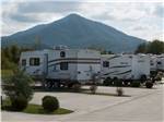 View larger image of RVs parked facing mountain at COVE CREEK RV RESORT image #2