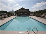View larger image of Large pool with mountains in distance at COVE CREEK RV RESORT image #5