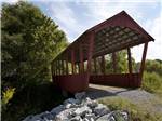 View larger image of Wooden bridge on walking path at COVE CREEK RV RESORT image #11