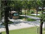 An RV parked at a shaded site - thumbnail