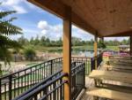 View larger image of Patio area with picnic tables overlooking lake at BRANCHES OF NIAGARA CAMPGROUND  RESORT image #12