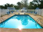 The fenced in swimming pool at SOUTHERN LIVING RV PARK - thumbnail