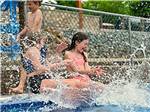 Kids splashing in the pool at STONYBROOK RV RESORT - thumbnail