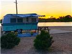 A trailer parked by the water at KEARNEY RV PARK & CAMPGROUND - thumbnail