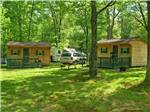 A couple of rental log cabins at WHISPERING PINES CAMPING ESTATES - thumbnail