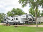 Parked travel trailer at site Texas Wine Country Jellystone Park Camp-Resort - thumbnail