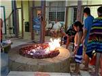 View larger image of Kids standing around a campfire pit at SANDPIPER RV RESORT image #3