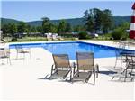 Swimming pool with outdoor seating at WINDEMERE COVE RV RESORT - thumbnail