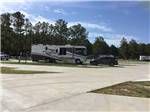 A row of paved RV sites at BLUE SKY LAKE LIVINGSTON RV PARK & CABINS - thumbnail