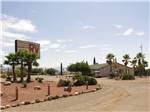 View larger image of Desert landscaping with park sign and office at TRADEWINDS RV PARK image #1