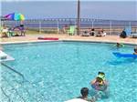 Guest enjoying the swimming pool at SANTA ROSA WATERFRONT RV RESORT - thumbnail