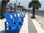 Blue lounge chairs next to the beach at SANTA ROSA WATERFRONT RV RESORT - thumbnail