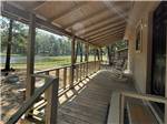 A covered porch with rocking chairs - thumbnail