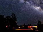 A motorhome parked under the starry night at PLUM NELLY RV PARK - thumbnail