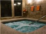 Indoor spa at night with orange towels hanging at PREFERRED RV RESORT - thumbnail