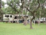 5th wheel parked at a tree lined site at LAKE MEDINA RV RESORT - thumbnail