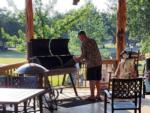 Man standing in front of a grill at LAKE MEDINA RV RESORT - thumbnail