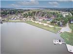 View larger image of Aerial view over water with resort in background at WATERS EDGE RV RESORT image #11