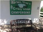 Campground sign and welcome bench at GREEN TREE'S CRAZY WOMAN CAMPGROUND - thumbnail