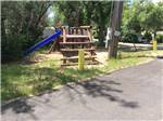 Playground area with blue slide at GREEN TREE'S CRAZY WOMAN CAMPGROUND - thumbnail