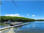 The dock with a pontoon boat at DUNROAMIN' TRAILER PARK & COTTAGES - thumbnail