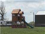 Tall kids play structure with slide at RUSTIC MEADOWS RV PARK - thumbnail