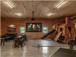 Big screen TV in rec room with play structure at RUSTIC MEADOWS RV PARK - thumbnail