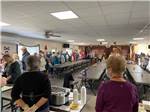 People lining up for a potluck dinner at GILA MOUNTAIN RV PARK - thumbnail