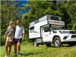 Camper with couple standing nearby - thumbnail