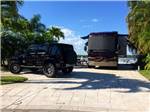 A motorhome and vehicle in a paved site - thumbnail